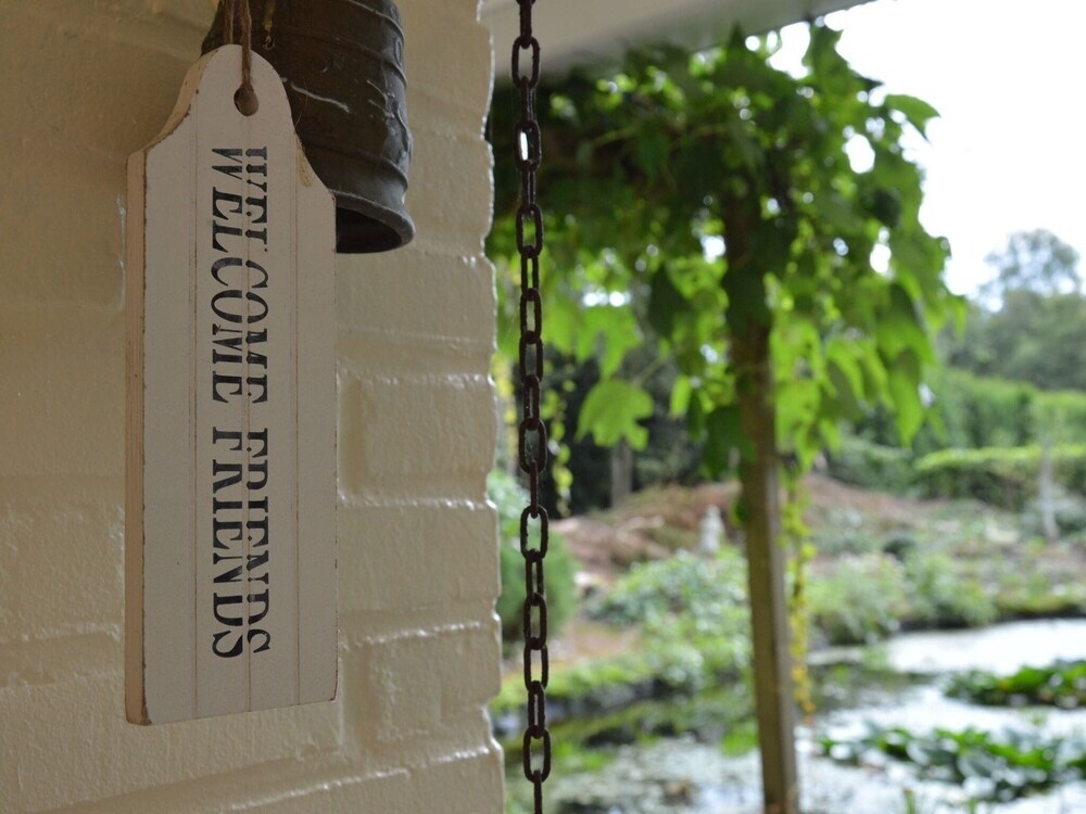 A Detached Bungalow With Outdoor Fireplace, Covered Terrace And Pond In A Forest Plot