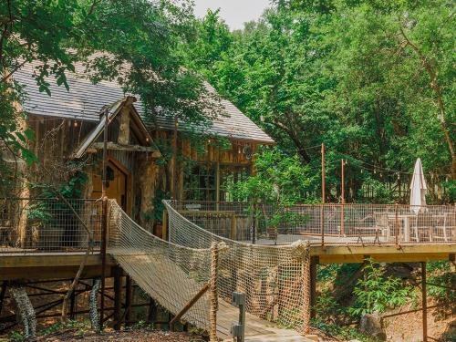 Hobbit Treehouse with waterfall on the Brazos River 350 acres Tubing Petting zoo